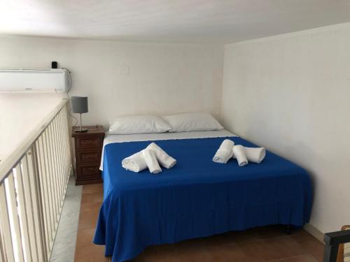 a bedroom with a blue bed with two pillows on it at IL PROFUMO DEL MARE in Palermo