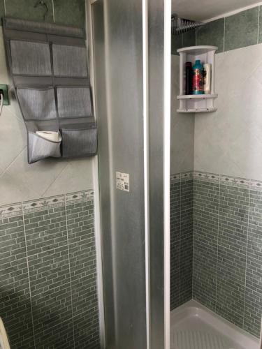 a shower with a stainless steel refrigerator in a bathroom at IL PROFUMO DEL MARE in Palermo