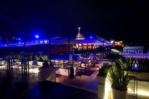a restaurant with tables and chairs at night at Casa 1810 Hotel Boutique in San Miguel de Allende
