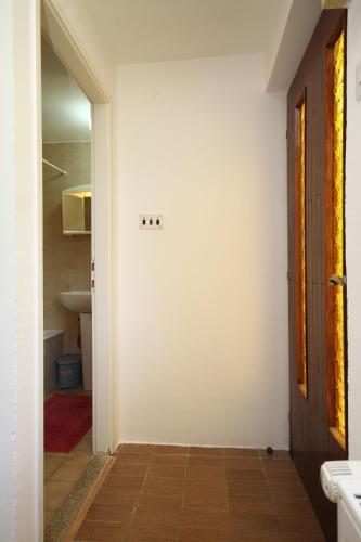 a hallway with a white wall and a door at Apartments with WiFi Opric, Opatija - 7756 in Lovran