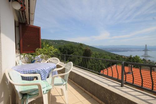 a table and chairs on a balcony with a view at Apartments with WiFi Opric, Opatija - 7756 in Lovran