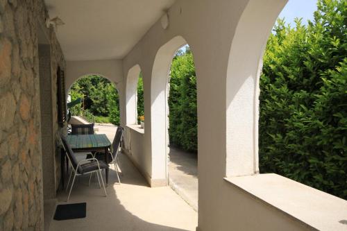 an outdoor patio with arches and a table and chairs at Apartments with WiFi Opric, Opatija - 7756 in Lovran