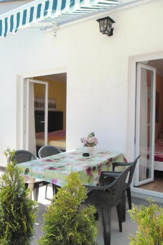 a table with a flowery table cloth on a patio at Apartments with WiFi Opric, Opatija - 7756 in Lovran