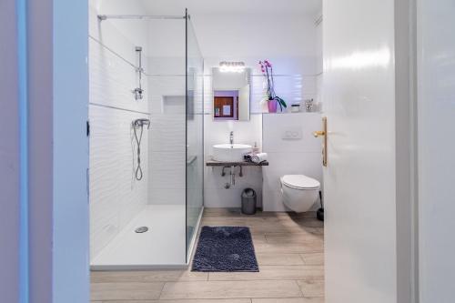 a white bathroom with a shower and a toilet at Apartments by the sea Lovran, Opatija - 7837 in Lovran
