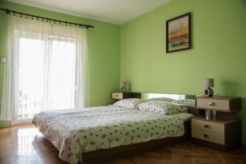 a green bedroom with a bed and a window at Apartments with a parking space Opric, Opatija - 7726 in Opric