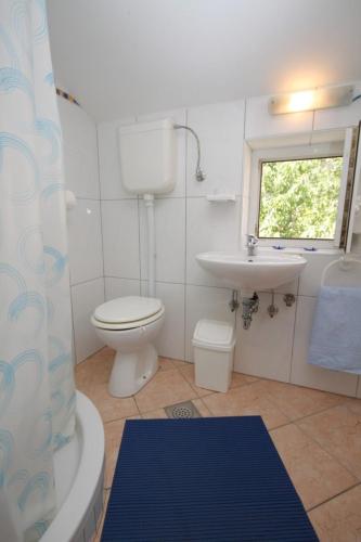 a bathroom with a toilet and a sink and a shower at Apartments with a parking space Medveja, Opatija - 7721 in Medveja