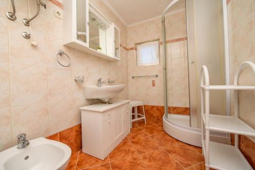 a bathroom with a sink and a toilet and a shower at Apartments by the sea Nerezine, Losinj - 7963 in Nerezine