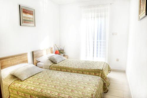 two beds in a bedroom with a window at Luxury villa with a swimming pool Opatija - Pobri, Opatija - 7843 in Matulji