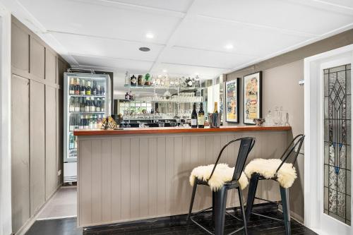 a bar with two chairs in front of it at The Bundanoon Guest House in Bundanoon