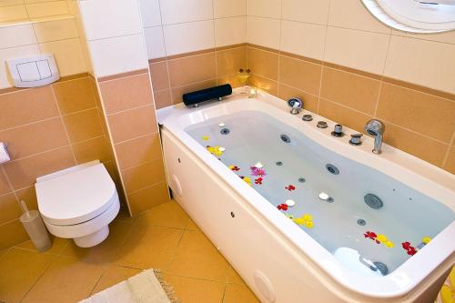 a bathroom with a tub and a toilet at Luxury villa with a swimming pool Opatija - Pobri, Opatija - 7843 in Matulji