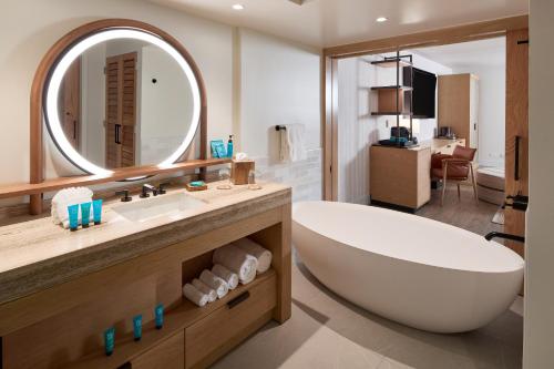 a bathroom with a sink, toilet and bathtub at Turtle Bay Resort in Kahuku