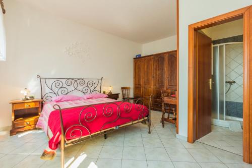 1 dormitorio con cama con colcha roja y escritorio en Rooms by the sea Moscenicka Draga, Opatija - 7767, en Mošćenička Draga