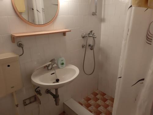 a bathroom with a sink and a mirror at Apartments by the sea Mali Losinj (Losinj) - 7996 in Mali Lošinj