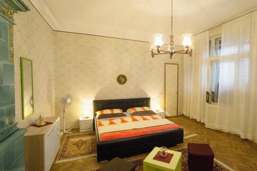 a bedroom with a bed and a chandelier at Apartments with a parking space Opatija - 7868 in Opatija