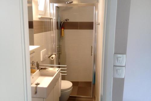 a bathroom with a toilet and a sink and a shower at Apartments with a parking space Opatija - 7919 in Opatija