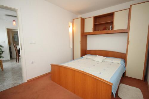 a bedroom with a wooden bed in a room at Apartment Opatija 7896a in Opatija