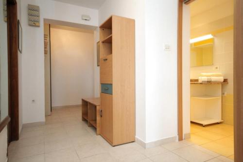 a room with a closet and a wooden cabinet at Apartments with a parking space Mali Losinj (Losinj) - 7998 in Mali Lošinj