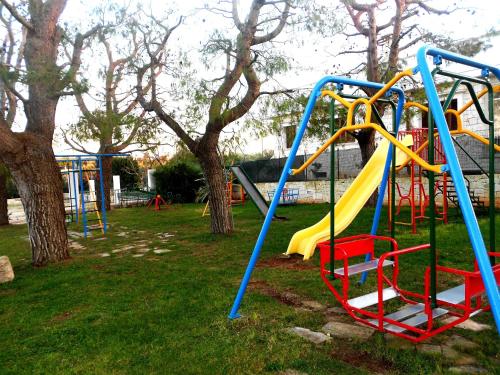 a playground with a slide in a park at Agriturismo Salinola in Ostuni