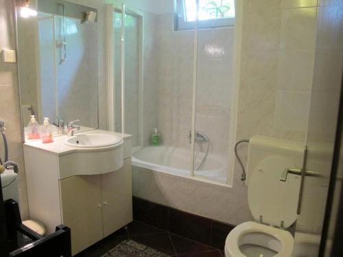 a bathroom with a toilet and a shower and a sink at Apartments by the sea Mali Losinj (Losinj) - 8002 in Mali Lošinj