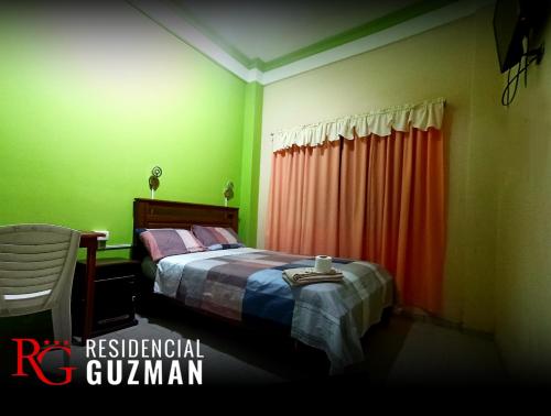 a bedroom with a bed and a red curtain at Residencial Guzmán 1 in Yacuiba