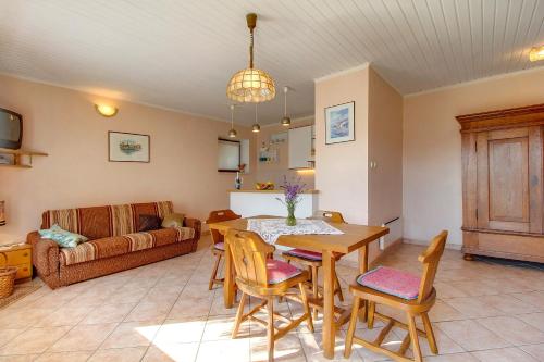 a living room with a table and chairs and a couch at Apartments by the sea Mali Losinj (Losinj) - 7974 in Mali Lošinj