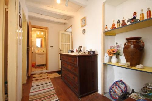 a room with a wooden dresser and a shelf at Holiday apartments Lastovo - 7790 in Lastovo