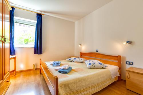 a bedroom with a bed with blue towels on it at Apartments with a parking space Mali Losinj (Losinj) - 8026 in Mali Lošinj