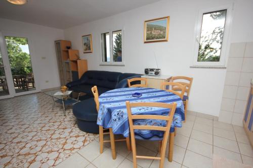 a living room with a table and chairs and a couch at Holiday house with a parking space Brsec, Opatija - 7795 in Brseč