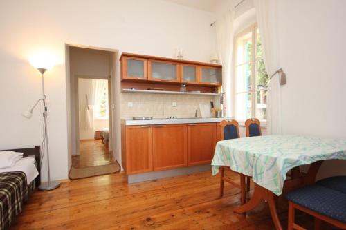 a room with a table and a kitchen with a table and chairs at Family friendly seaside apartments Moscenicka Draga, Opatija - 7798 in Mošćenička Draga