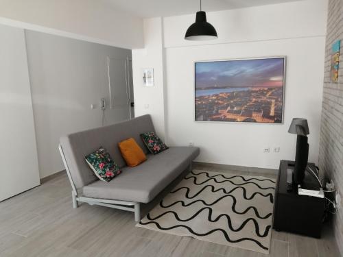 a living room with a couch and a rug at Paradise Space in Lisbon