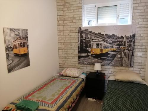 two beds in a room with two trains on the wall at Paradise Space in Lisbon
