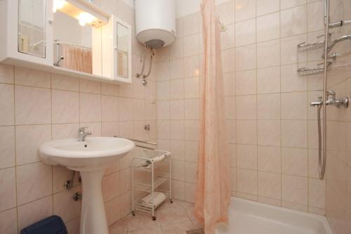 ein Bad mit einem Waschbecken und einer Dusche in der Unterkunft Apartments by the sea Opatija - Volosko, Opatija - 7911 in Opatija