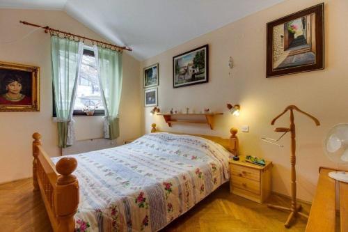 a bedroom with a large bed and a window at Apartments with a parking space Mali Losinj (Losinj) - 8000 in Mali Lošinj