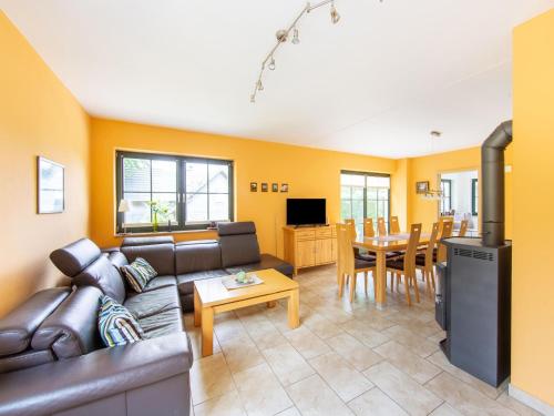 a living room with a couch and a table at Forest Escape with Terrace in Eisfeld