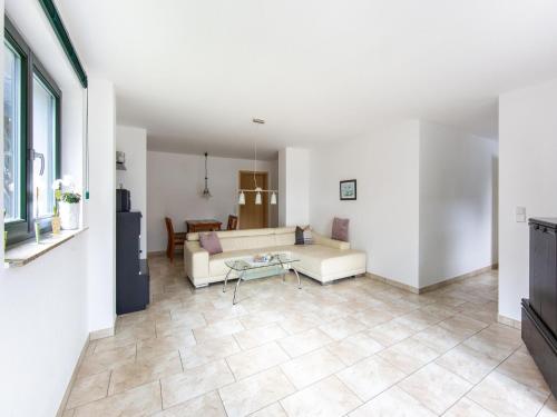 a living room with a couch and a table at Comfortable apartment in Eisfeld with bicycle storage in Eisfeld