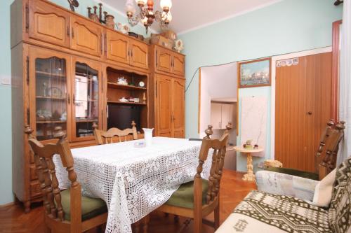 a dining room with a table and chairs at Apartments by the sea Cres - 7875 in Cres