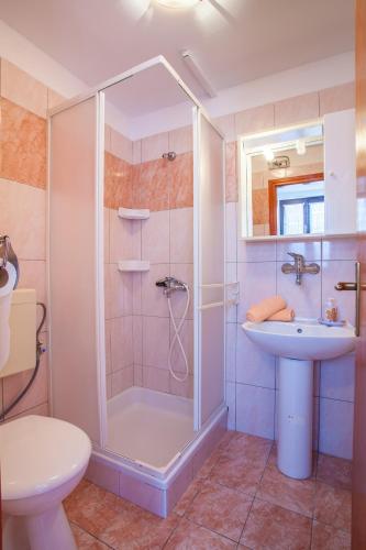 a bathroom with a shower and a sink and a toilet at Apartments with parking space Cres - 7983 in Cres