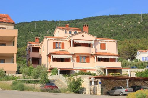 a large house with cars parked in front of it at Apartments with a parking space Cres - 7985 in Cres