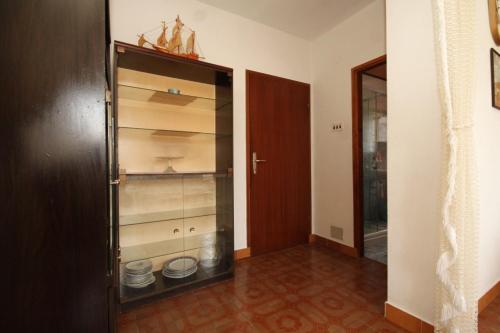 a room with a closet with shelves and a door at Apartments by the sea Mali Losinj (Losinj) - 8027 in Mali Lošinj