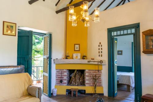 a living room with a fireplace and a couch at FINCA COCUYAL Hospedaje típico paisa in Rionegro