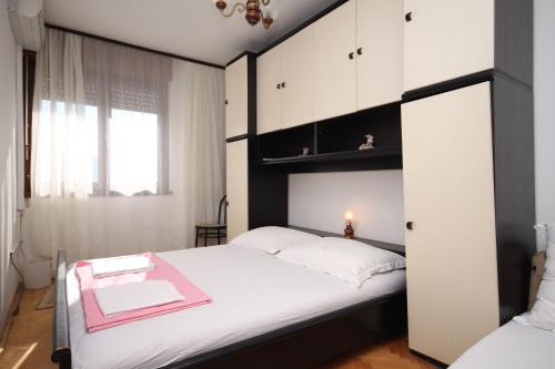 a bedroom with a black and white bed and a window at Rooms with WiFi Split - 9240 in Split