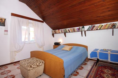 a bedroom with a bed with a wooden ceiling at Seaside holiday house Brna, Korcula - 9235 in Smokvica