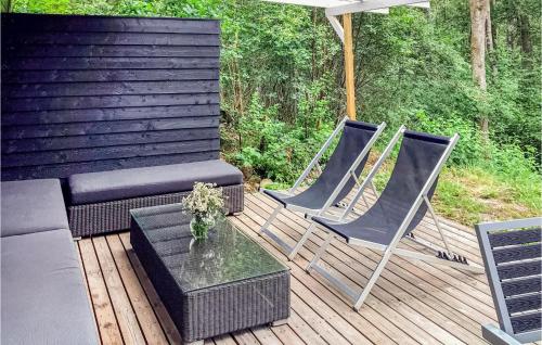 two chairs and a couch on a wooden deck at Knäred in Knäred