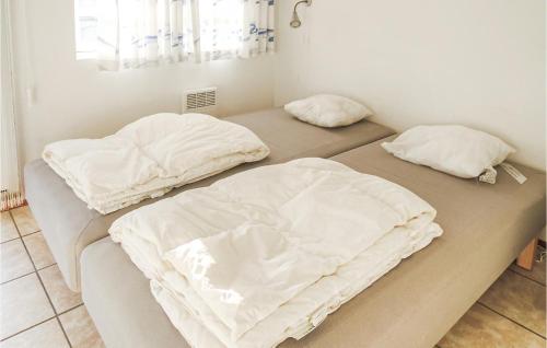 two beds with white sheets on them in a room at Knäred in Knäred
