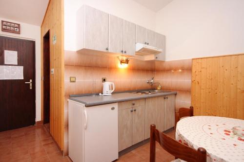 a small kitchen with a sink and a table at Apartment Prizba 9227b in Prizba