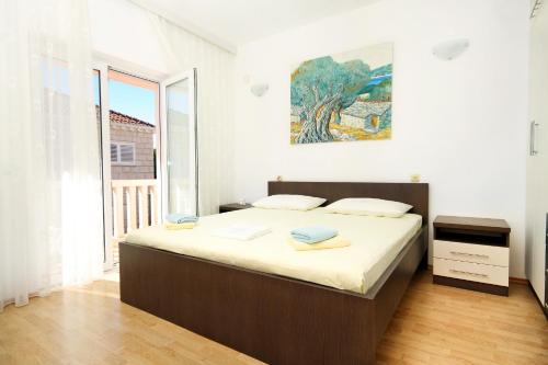 a bedroom with a large bed in a room at Apartments by the sea Lumbarda, Korcula - 9300 in Lumbarda