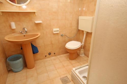a small bathroom with a toilet and a sink at Apartments by the sea Lumbarda, Korcula - 9263 in Lumbarda