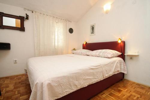 a bedroom with a large bed in a room at Apartments by the sea Korcula - 9217 in Korčula