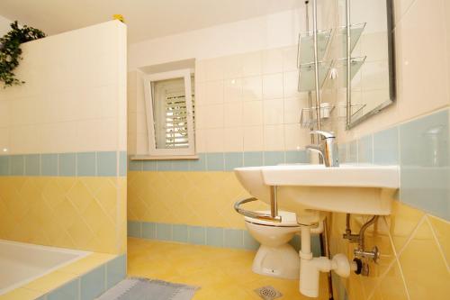 a bathroom with a sink and a toilet at Apartments and rooms by the sea Korcula - 9267 in Korčula