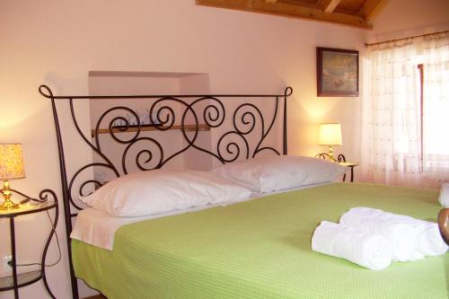 a bedroom with a large bed with a green blanket at Apartments with a parking space Komiza, Vis - 9247 in Komiža